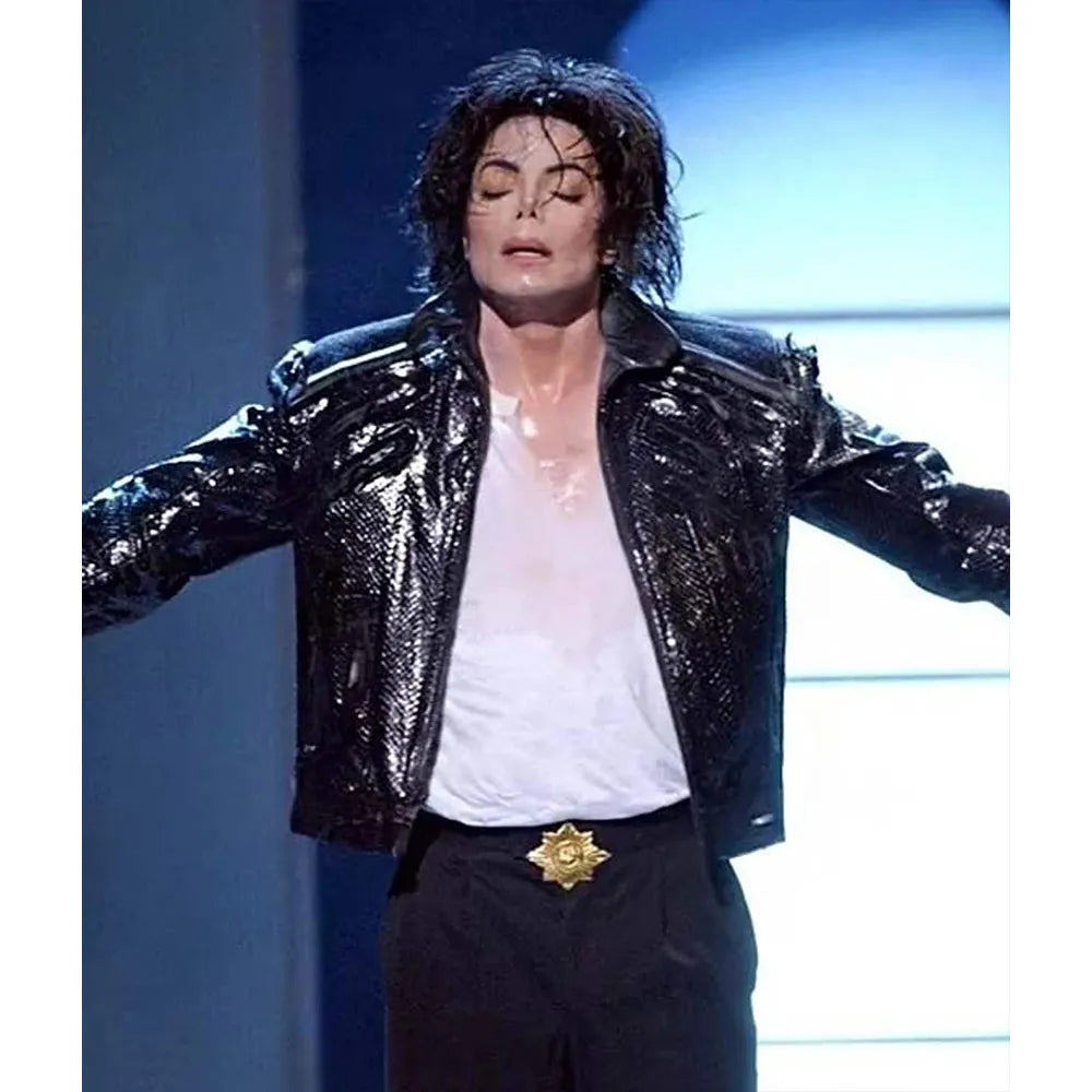 Person wearing a shiny black jacket with arms outstretched on a blue and white background