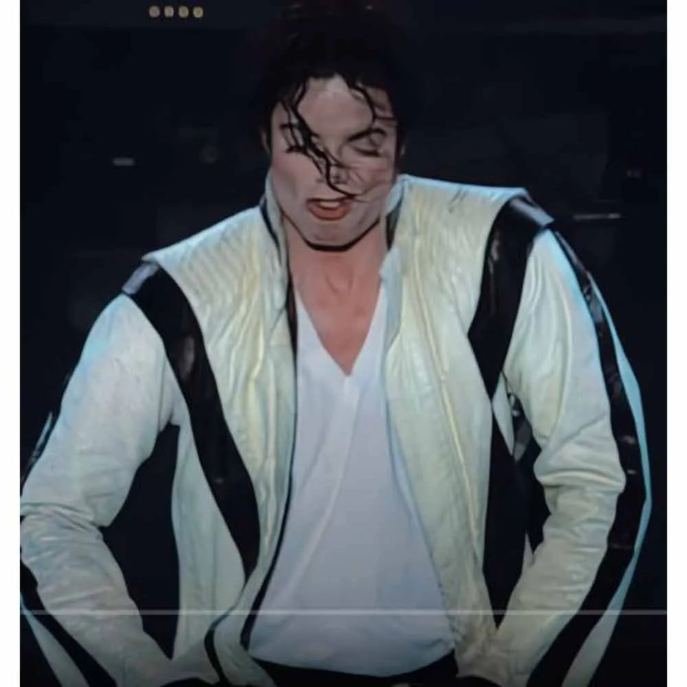 Person wearing a zebra-striped outfit with a white shirt underneath, against a dark background.